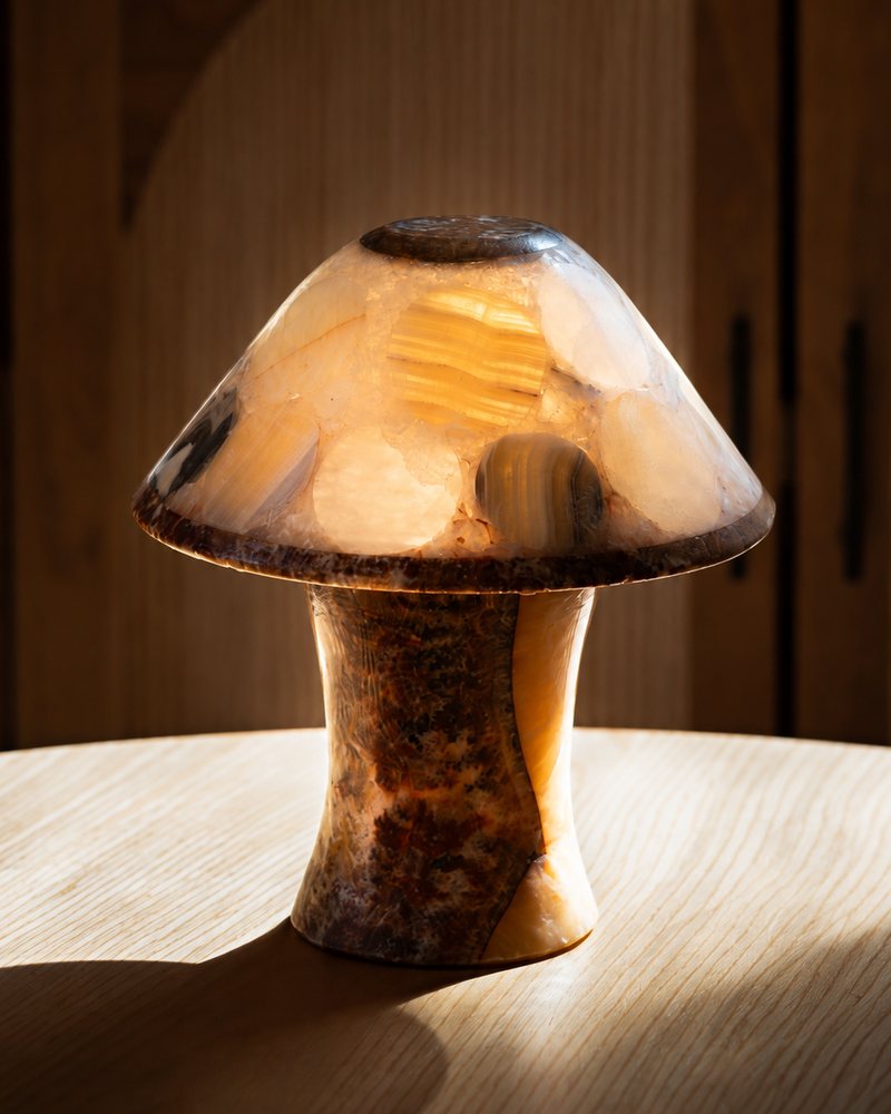 Stone mushroom lamp glowing on a wooden table